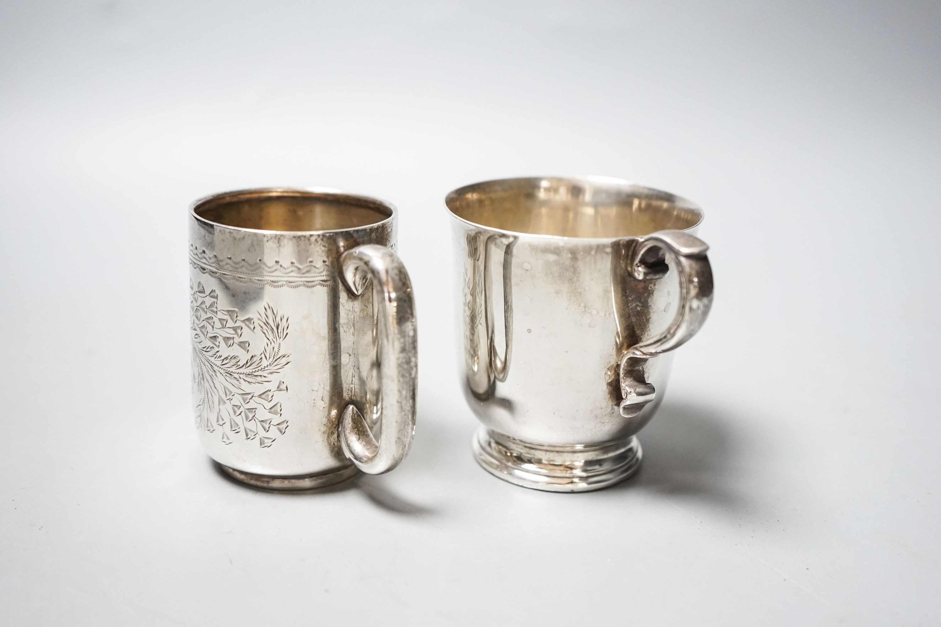 An Edwardian engraved silver christening mug, Chester, 1906, 73mm and a later silver mug, 6.5oz.